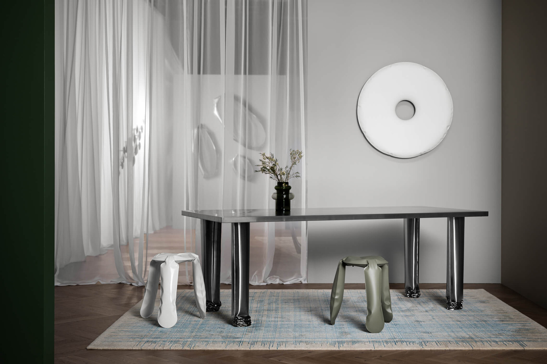 inflated seatings in composition with steel mirror and table from zieta studio