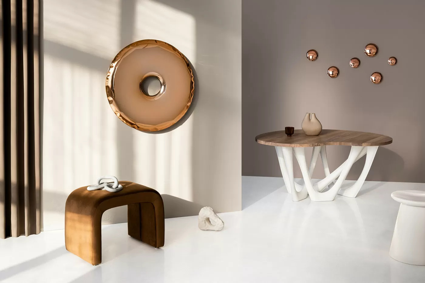 a inflated steel mirror in minimalistic interior setting